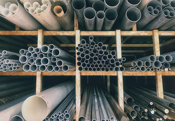 Pipe Steel and PVC plumbing pipes on a rack